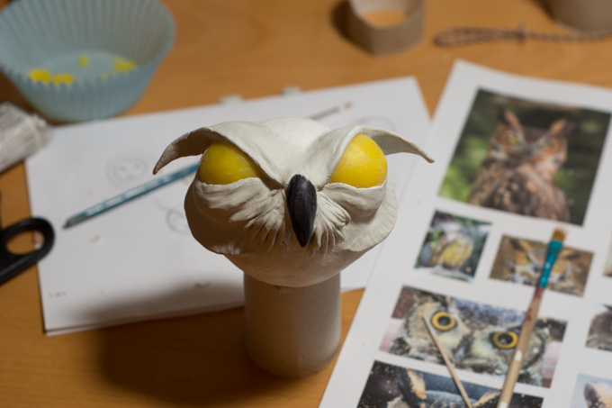 an owl ornament in progress. It is unpainted but got yellow eyes and a black beak
