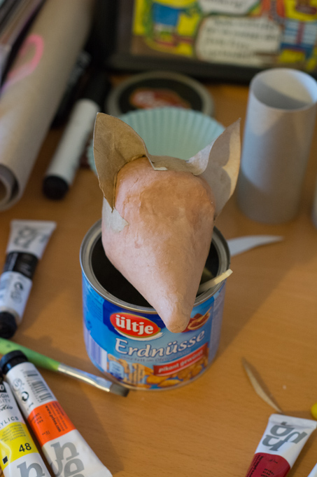 a paper ball with a paper cone for nose and two toilet roll pieces as ears
